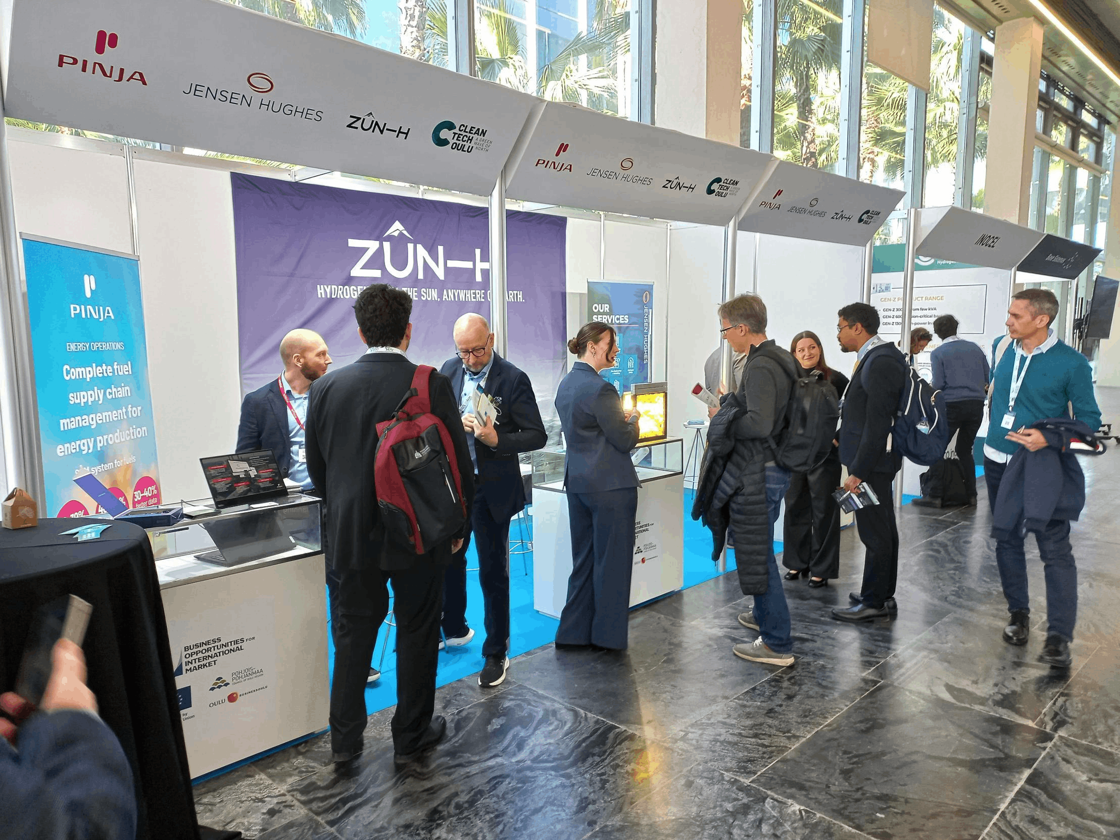 Lots of people in front of the BusinessOulu stand.