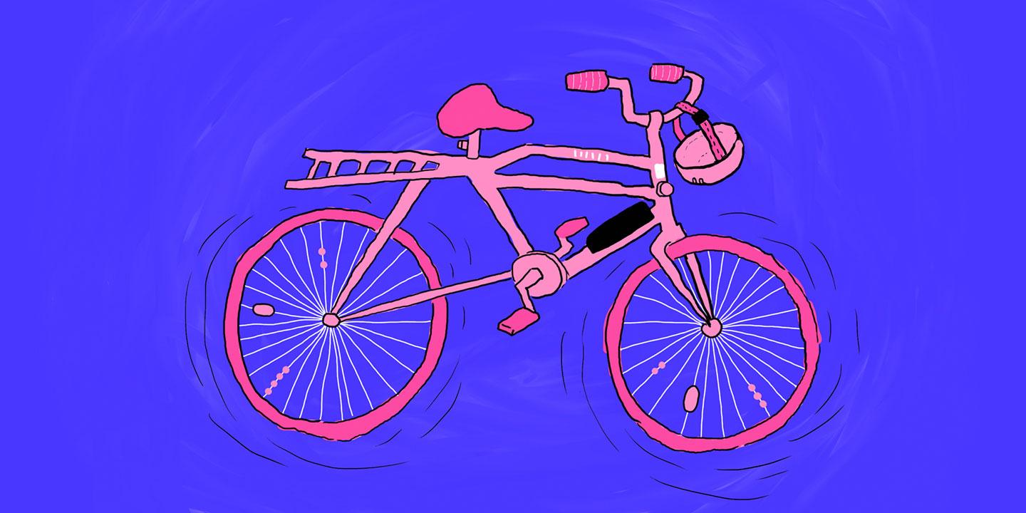 Vaaleanpunainen polkupyörä ja pyöräilykypärä