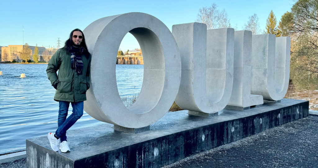 International man standing next to Oulu-letters