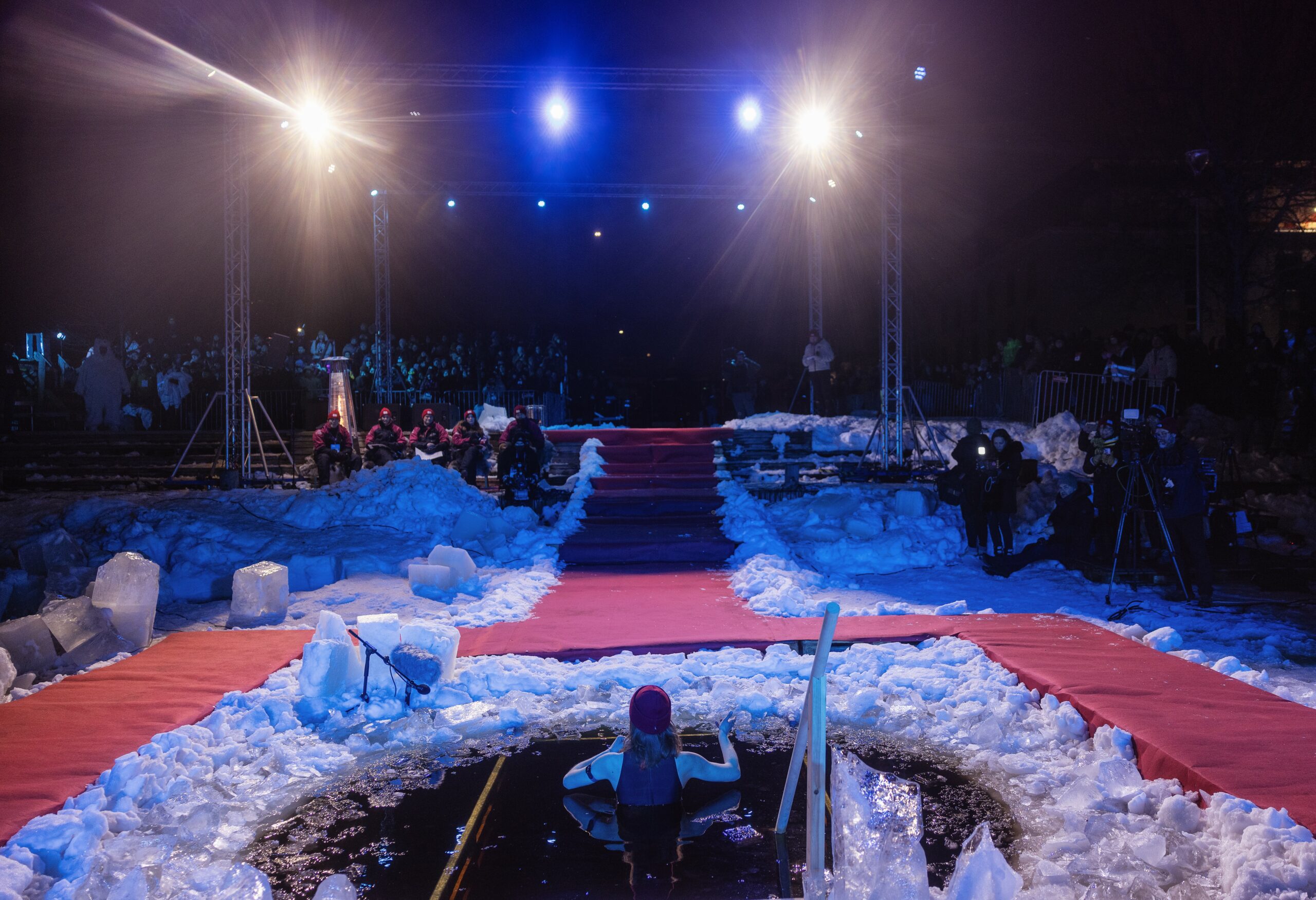 Person pitching in an ice hole in Polar Bear Pitching 2024 event in Oulu